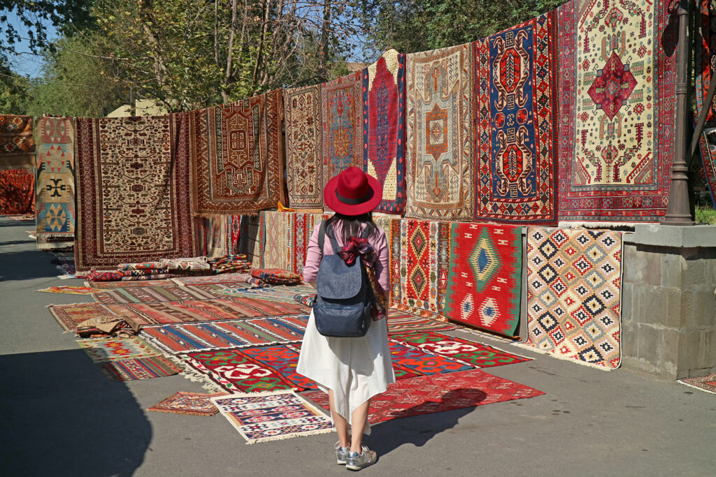 female traveler impressed by stunning carpets vernissage market downtown yerevan armenia