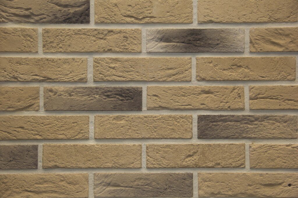 light brown stone brick exterior wall hard light emphasizing stone s textures depth