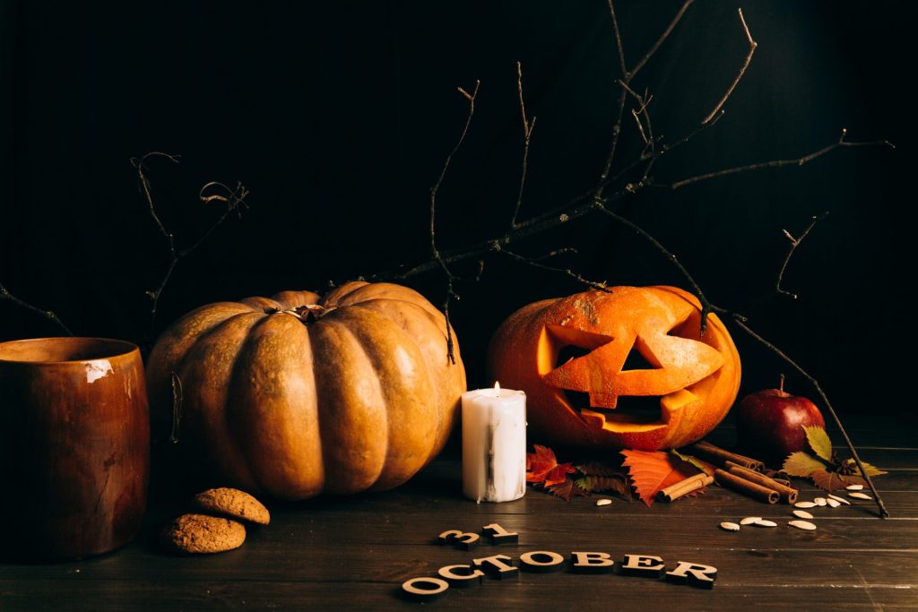 wooden lettering 31 october lie before large scarry hallooween pumpkins